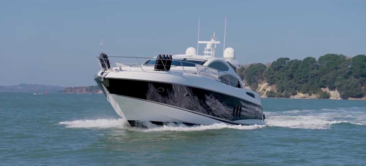 Mojo yacht in motion along the Jurassic Coast with dramatic coastal backdrop